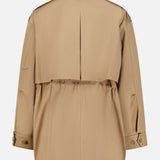 The Drawing Conclusions Jacket by TWP, shown from the back in beige, features a center pleat, adjustable waist, buttoned cuffs, and a vented yoke—an essential workwear piece for women balancing style and function.
