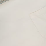 Close-up of the TWP Ex T Shirt With Crystal Collar: a white cropped cotton women’s workwear top featuring a visible chest pocket and a sparkling beaded crystal-embellished collar.
