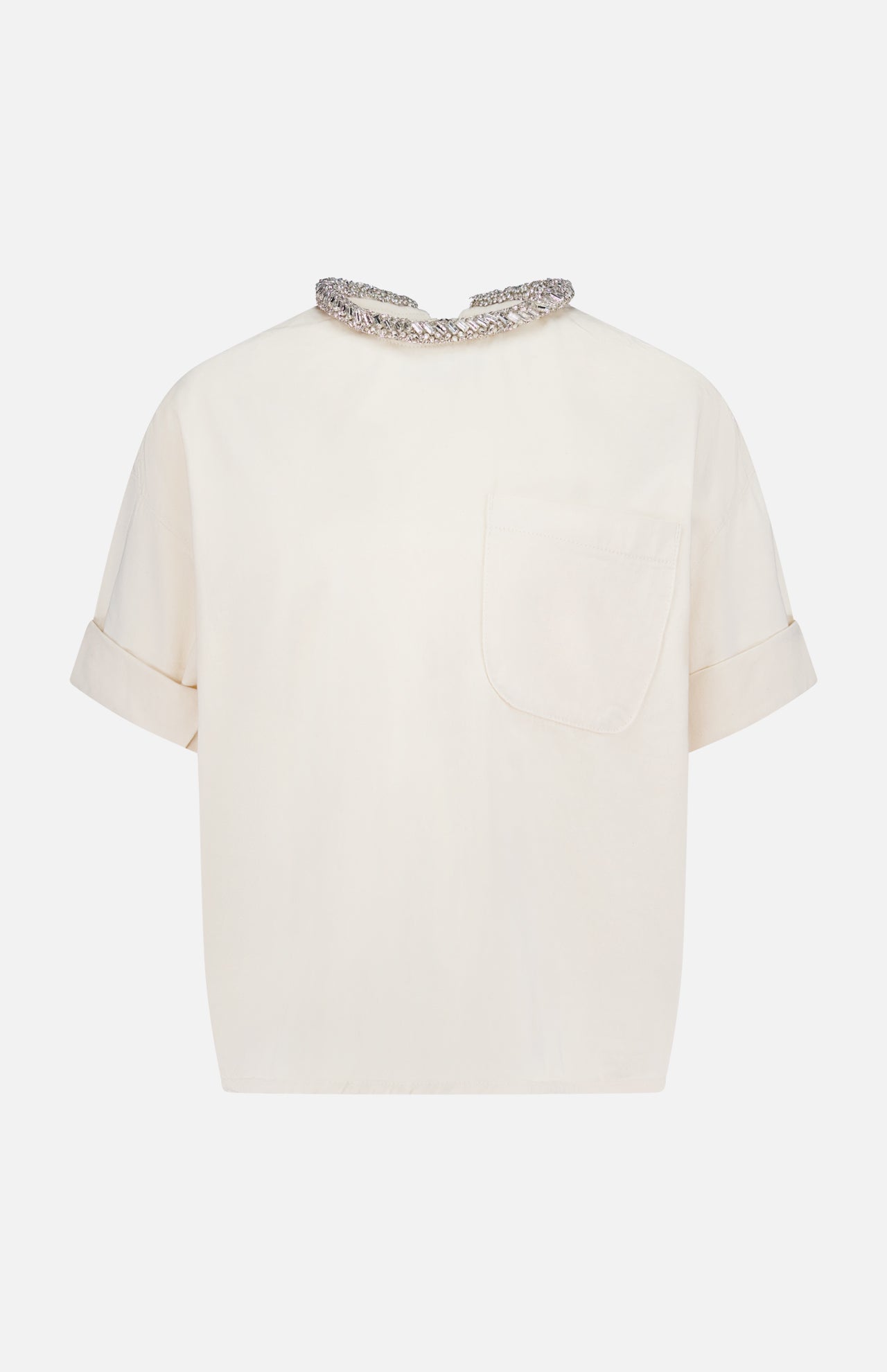 The TWP Ex T Shirt With Crystal Collar is a women's short-sleeved, off-white workwear top featuring a single front pocket, turned-up cuffs, and a decorative crystal collar.