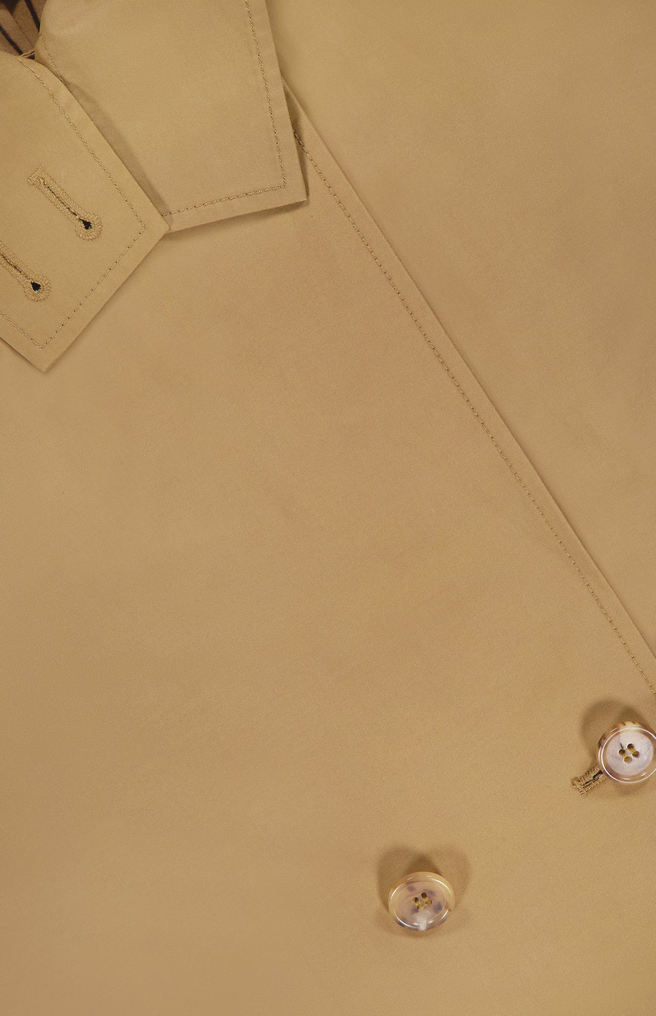 Close-up of the TWP Fringe Benefit Jacket shows its water-repellent fabric, detailed stitching, collar with buttonholes, and two light-colored buttons. The material's texture is clearly visible.