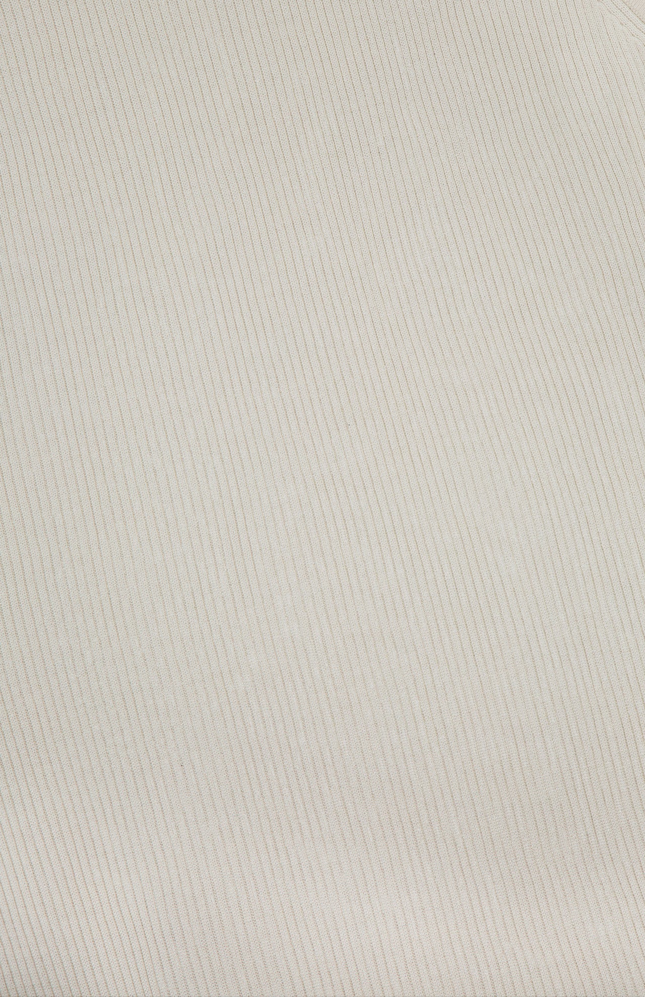 A close-up of light beige fabric with fine, diagonal pinstripes running parallel across the surface. The smooth and soft texture makes it a perfect choice for the TWP Harbor Racerback Tank Top, adding a touch of sophistication to contemporary workwear for women.