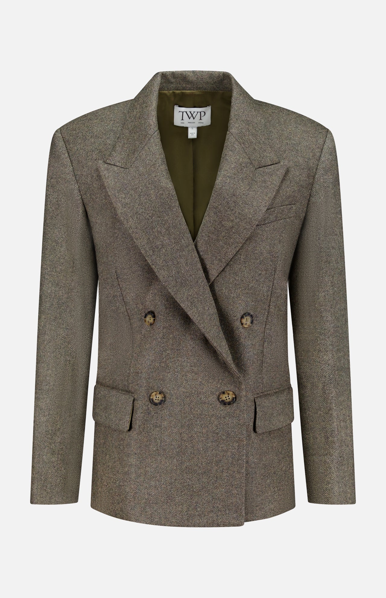 A double-breasted, olive-green wool blazer—the Harper Herringbone Blazer by TWP—features peaked lapels, four buttons, flap pockets, and a TWP label inside the collar, offering a sophisticated alternative to the classic women's grey blazer or herringbone workwear jacket.