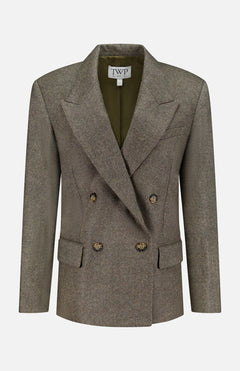 A double-breasted, olive-green wool blazer—the Harper Herringbone Blazer by TWP—features peaked lapels, four buttons, flap pockets, and a TWP label inside the collar, offering a sophisticated alternative to the classic women's grey blazer or herringbone workwear jacket.