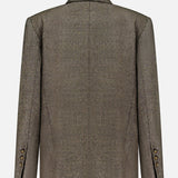 The Harper Herringbone Blazer by TWP is showcased from the back, highlighting its notched collar, structured shoulders, and cuff button accents. Inspired by the classic double-breasted wool blazer, it features a subtly textured herringbone fabric for an elevated finish.