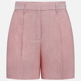 The TWP Henry St Stripe Short—pink high-waisted women's shorts with subtle vertical stripes, belt loops, and front pleats—offers stylish workwear appeal, shown on a plain white background.