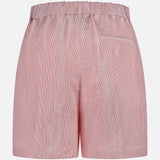 Back view of TWP’s Henry St Stripe Short, a pair of light pink pinstriped women’s pleated, mid-rise shorts with an elastic waistband and right welt pocket. These shorts blend comfort and style for any occasion.