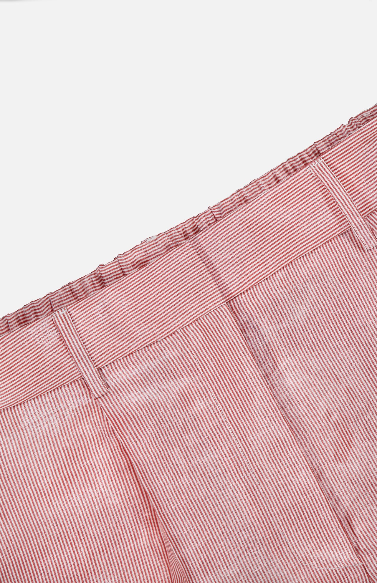 Close-up of the Henry St Stripe Short by TWP, featuring red and white vertical stripes and an elastic waistband, photographed against a white background.