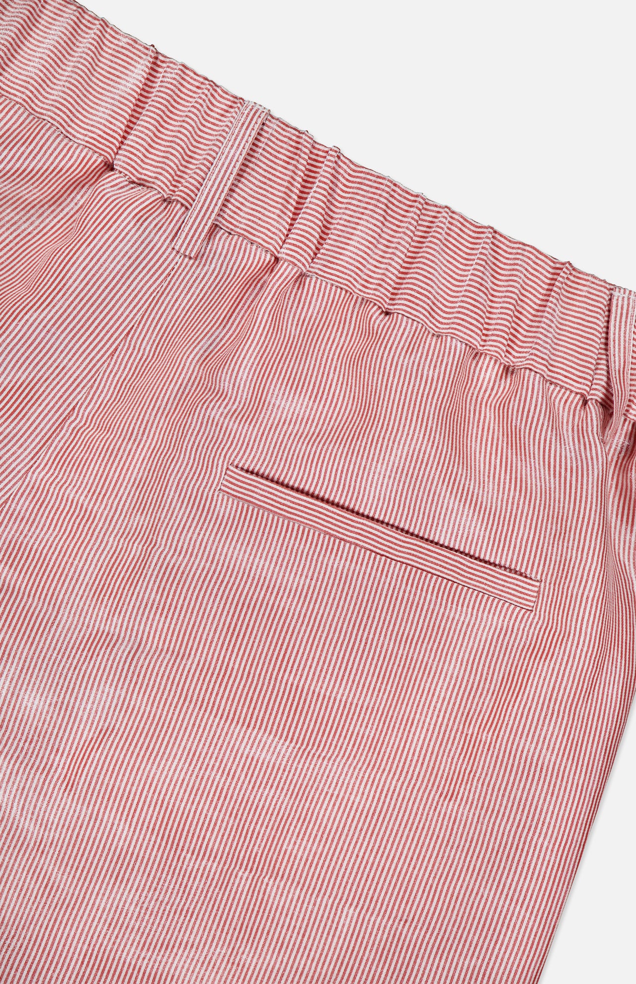 Close-up of TWP’s Henry St Stripe Short: red and white vertical stripes, pleated design, elastic waistband, belt loops, and a single back pocket with a horizontal opening.