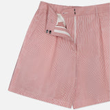 The TWP Henry St Stripe Short features red and white pinstripes, a mid-rise fit, front zipper and button closure, partially unzipped to show the interior waistband and lining—ideal for stylish workwear. Displayed on a white background.
