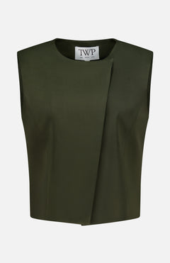 The High Neck Hidden Placket Vest by TWP is a sleeveless, dark olive green cropped top designed in a minimalist style. It features an asymmetrical front fold, round neckline, and a visible white label with the brand’s name inside. Ideal for women seeking refined yet contemporary workwear, this modern vest is photographed against a plain white background.