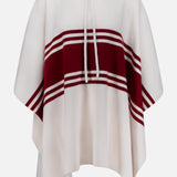 The TWP Hooded Cashmere Stripe Poncho showcases a cream base with a central maroon stripe and two thin maroon stripes, a neck drawstring, and a loose, flowing fit for effortless style.