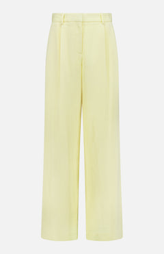 The TWP Hudson St Pleated Pant features a high waist, wide legs, belt loops, and front pleats for a modern workwear look. This tailored yellow pant for women is displayed against a plain white background.