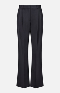 The Ivy Pleated Trouser Pant by TWP showcases a sophisticated workwear option for women, featuring black tailored pants with belt loops, front pleats, and a slight flare at the hem in a mid-rise silhouette, all presented against a plain white background.