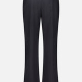 Back view of the TWP Ivy Pleated Trouser Pant in black Italian wool, featuring belt loops, a single buttoned back pocket on the right, and a straight-leg cut. Crafted from tailored, formal material, these mid-rise pants are an ideal choice for elevated women’s workwear.