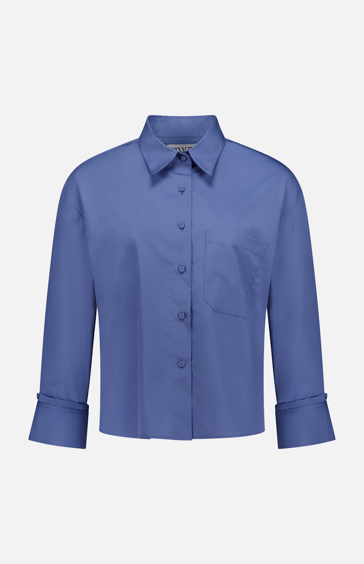 The TWP J.D.S Cropped Shirt is a women's boxy fit, long sleeve blue shirt with a collar, chest pocket, and wide cuffs, shown against a plain white background.