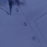 A close-up of the J.D.S Cropped Shirt by TWP, featuring a visible collar, buttons, part of a chest pocket, and an inner collar label displaying the brand name TWP.