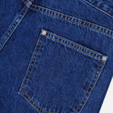 Close-up of the back pocket and waistband of the TWP Kent St Jean in Dark Stone, highlighting the detailed stitching and textured denim fabric.