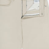A pair of Kent St Pant in Bone by TWP, these mid-rise women’s straight-leg jeans feature a classic five-pocket design, with the front zipper and button partially open to reveal the inner label and waistband tag reading TWP.