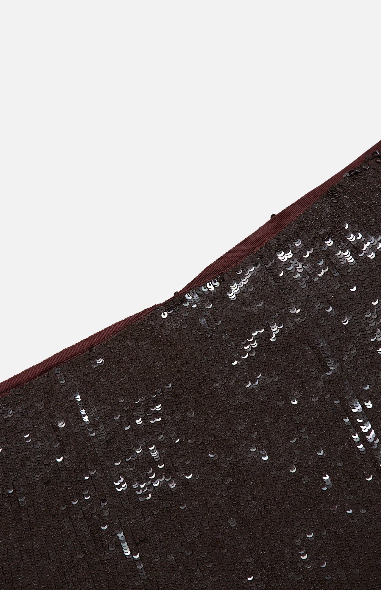 Close-up of a dark brown TWP Ladylike Midi Skirt featuring sequin fabric, a thick waistband, and a front slit.