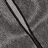 A close-up of the black mesh fabric on TWP's Sheer Sequin Muscle Tank, showing a diagonal seam and grid-like textured pattern against a white background.