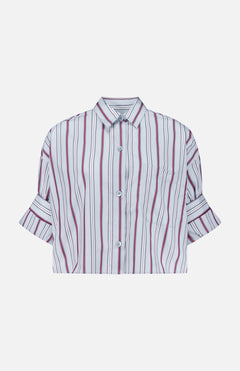 The Next Ex Striped Blouse by TWP is a cropped, boxy shirt featuring vertical red, black, and white stripes. Designed with short sleeves, a button-up front, collar, front pocket, and folded cuffs, this stylish piece is an ideal workwear option for women. Shown against a plain white background.