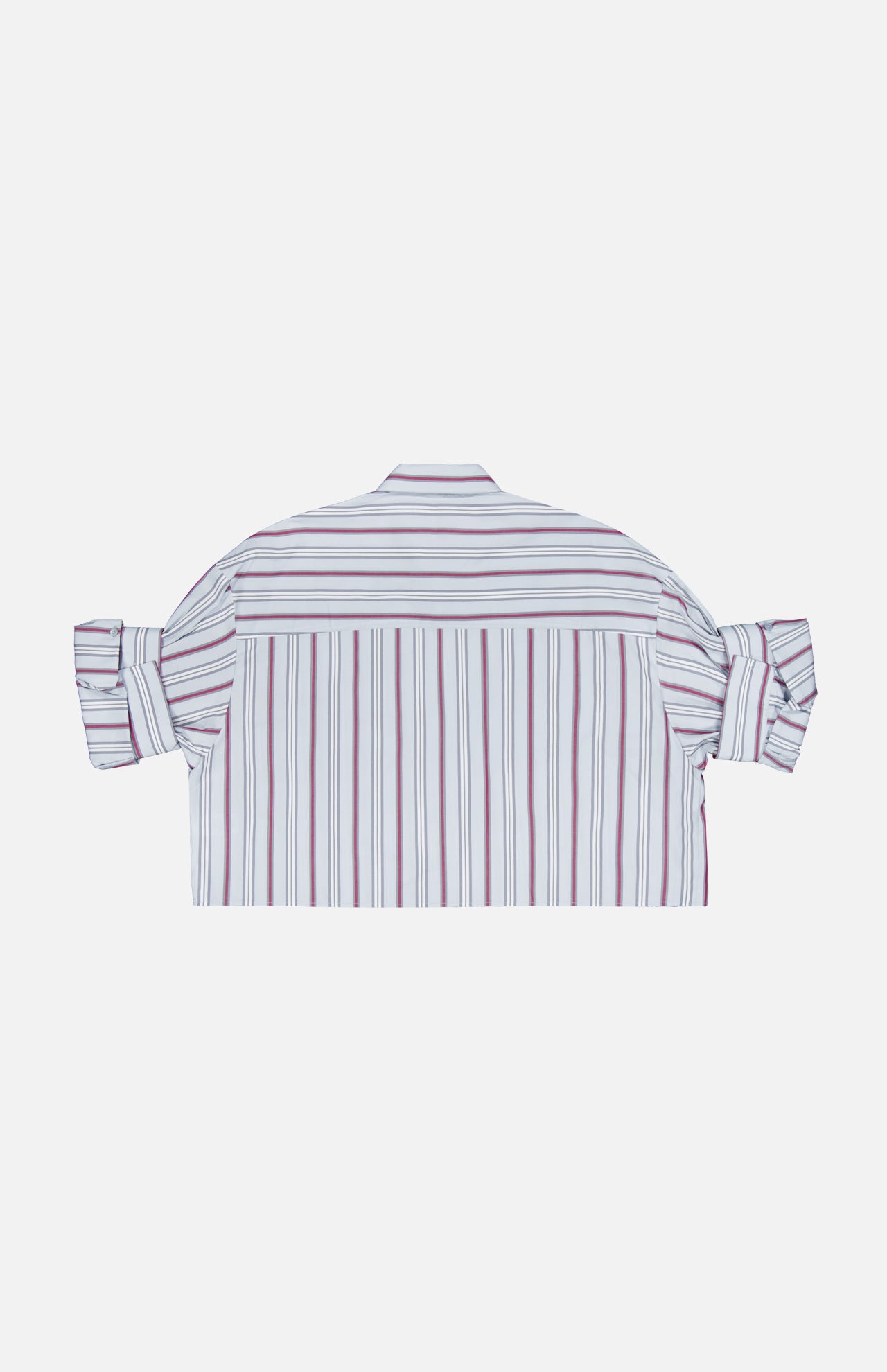 A back view of the TWP Next Ex Striped Blouse—a cropped, boxy white button-up shirt with vertical red and blue stripes and rolled-up sleeves—laid flat on a plain white background, presenting a stylish workwear option for women.