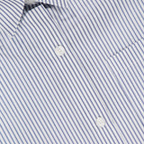 Close-up of the TWP Next Ex Striped Cropped Blouse featuring thin blue vertical stripes, white buttons, a pocket, and a collar—a versatile women’s workwear piece displaying the TWP label.
