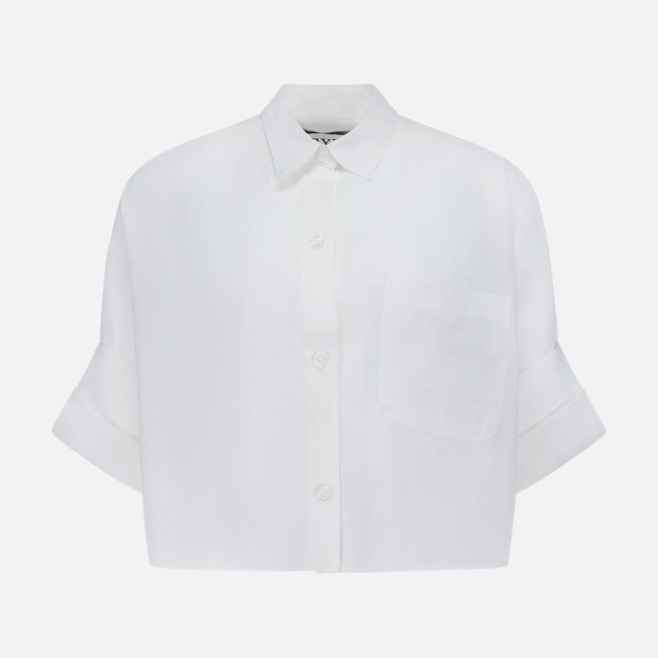 The TWP Next Ex Shirt in Linen is a white, cropped, boxy women's shirt with short sleeves, a collar, front pocket, and cuffs—perfect for workwear and shown against a plain background.