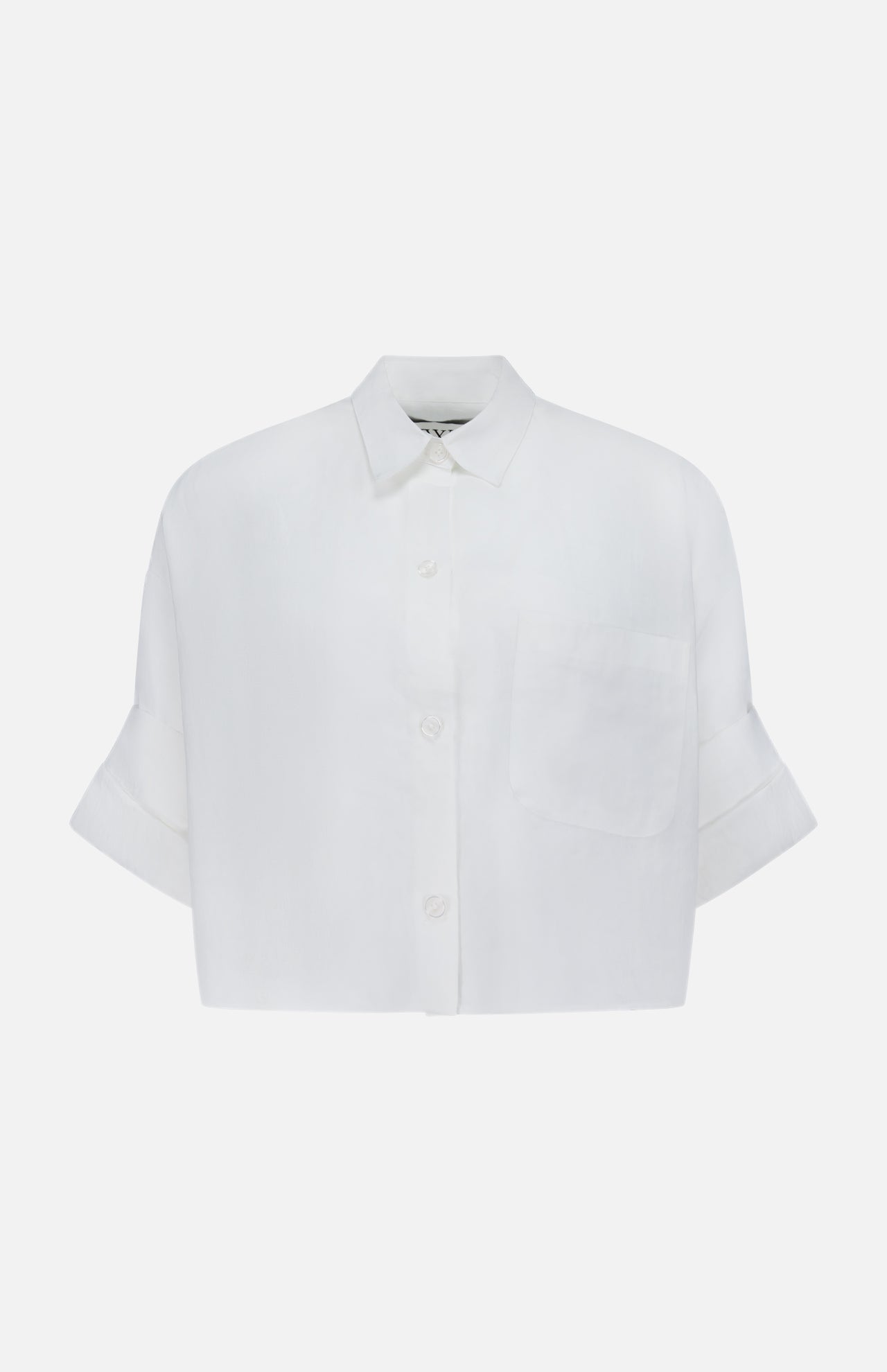 The TWP Next Ex Shirt in Linen is a white, cropped, boxy women's shirt with short sleeves, a collar, front pocket, and cuffs—perfect for workwear and shown against a plain background.