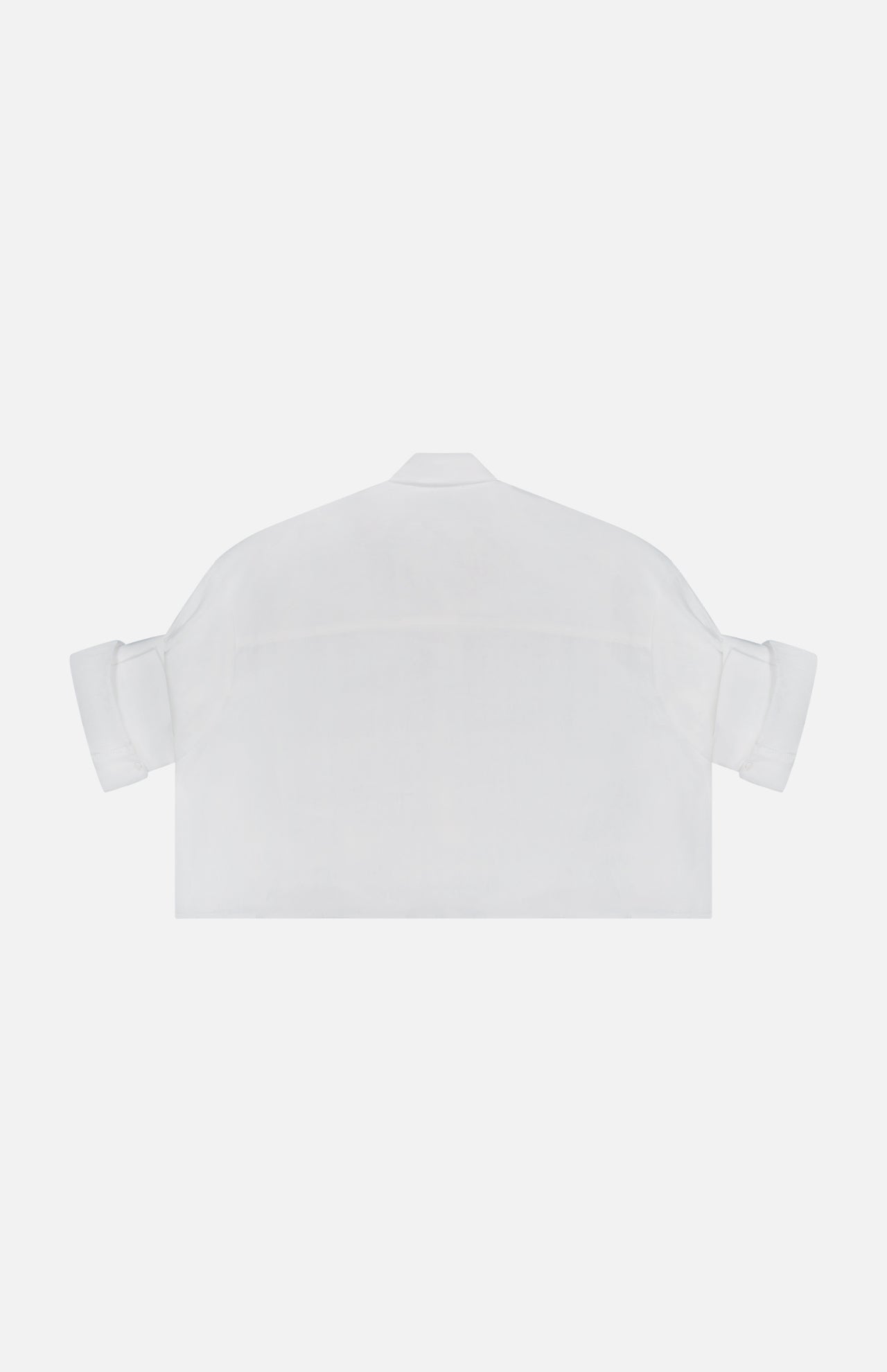 The TWP Next Ex Shirt in Linen is a white, cropped, boxy shirt with rolled-up sleeves and a minimal design—ideal for women’s workwear—shown from the back against a white background.