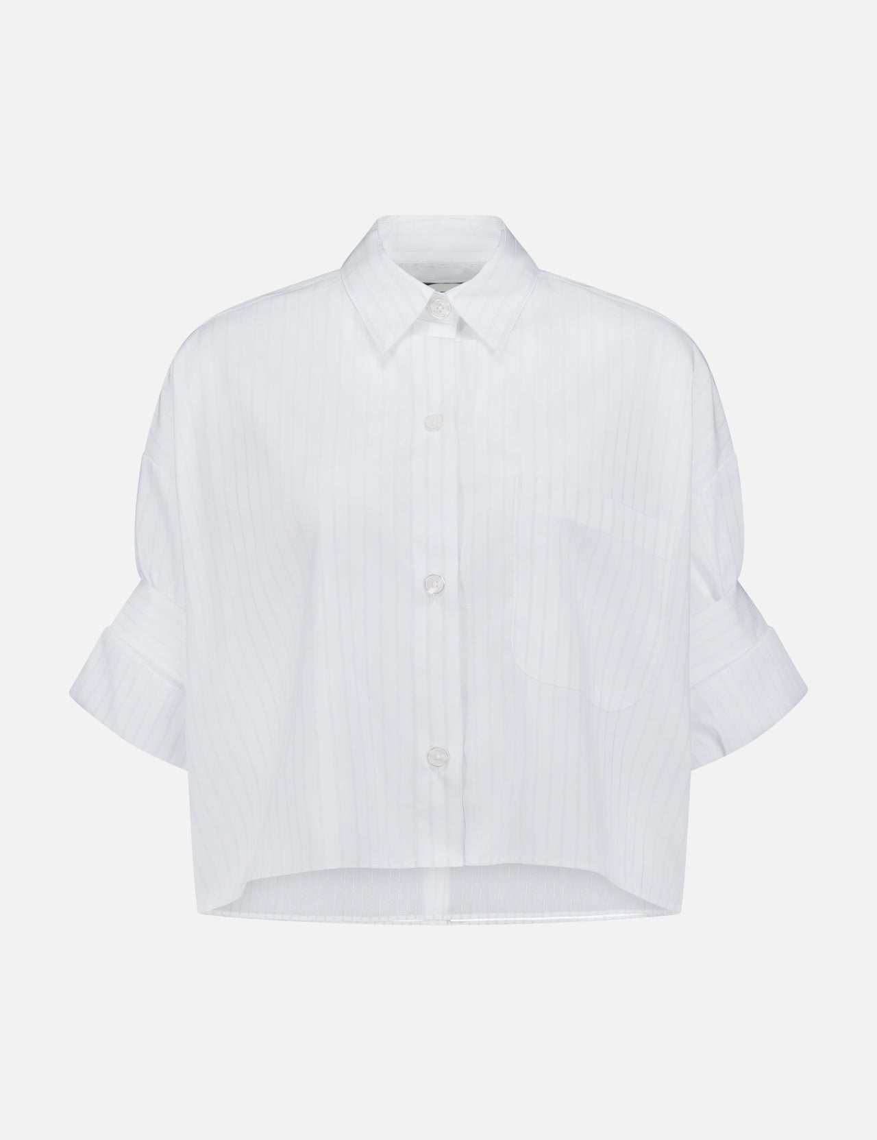 The TWP Next Ex Cropped Stripe Shirt is a white, short-sleeved, collared top with subtle vertical pinstripes, a chest pocket, rolled sleeves, and a straight cropped hem—ideal for modern women's workwear.