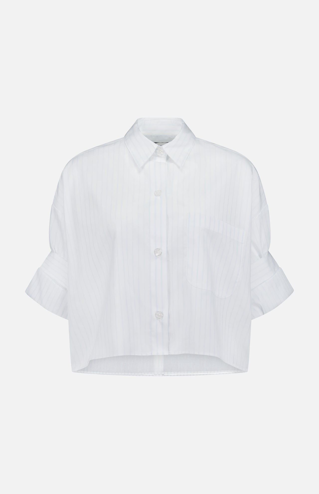 The TWP Next Ex Cropped Stripe Shirt is a white, short-sleeved, collared top with subtle vertical pinstripes, a chest pocket, rolled sleeves, and a straight cropped hem—ideal for modern women's workwear.