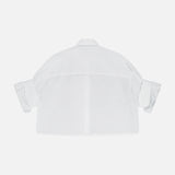 Back view of the TWP Next Ex Cropped Stripe Shirt—a white, short-sleeve, boxy-fit shirt with cuffed sleeves—displayed on a plain background; ideal for stylish modern women's workwear.