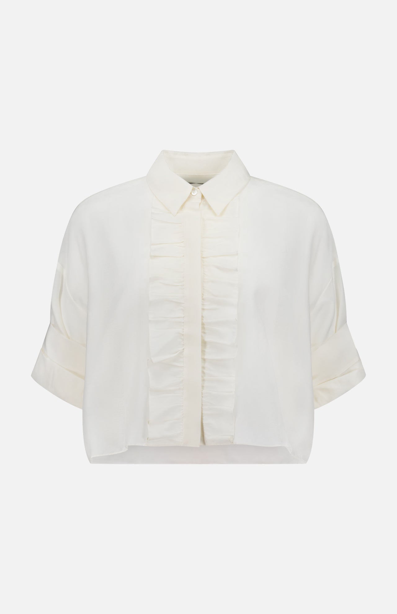 The TWP Next Ex Ruffle Blouse is a short-sleeved, white cropped blouse with a classic collar, front button placket, vertical ruffles, rolled cuffs, and a slightly cropped hem—an ideal versatile workwear choice for women.