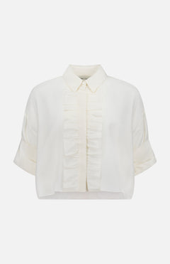 The TWP Next Ex Ruffle Blouse is a short-sleeved, white cropped blouse with a classic collar, front button placket, vertical ruffles, rolled cuffs, and a slightly cropped hem—an ideal versatile workwear choice for women.