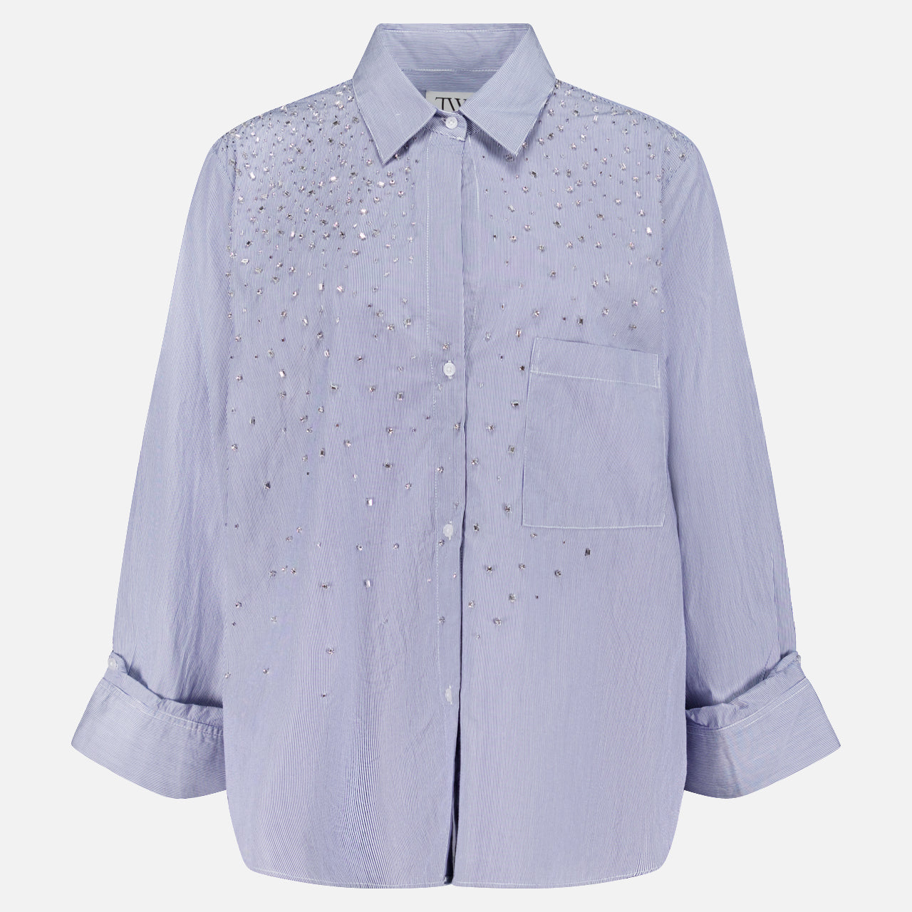 The TWP Next Morning Shirt with Crystals is a light purple, oversized Italian cotton button-down featuring a collar, front pocket, and sparkling crystal embellishments on the chest and shoulders.