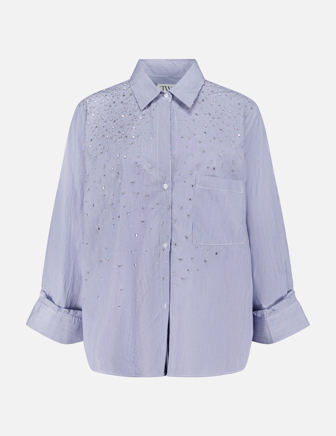 The TWP Next Morning Shirt with Crystals is a light purple, oversized Italian cotton button-down featuring a collar, front pocket, and sparkling crystal embellishments on the chest and shoulders.