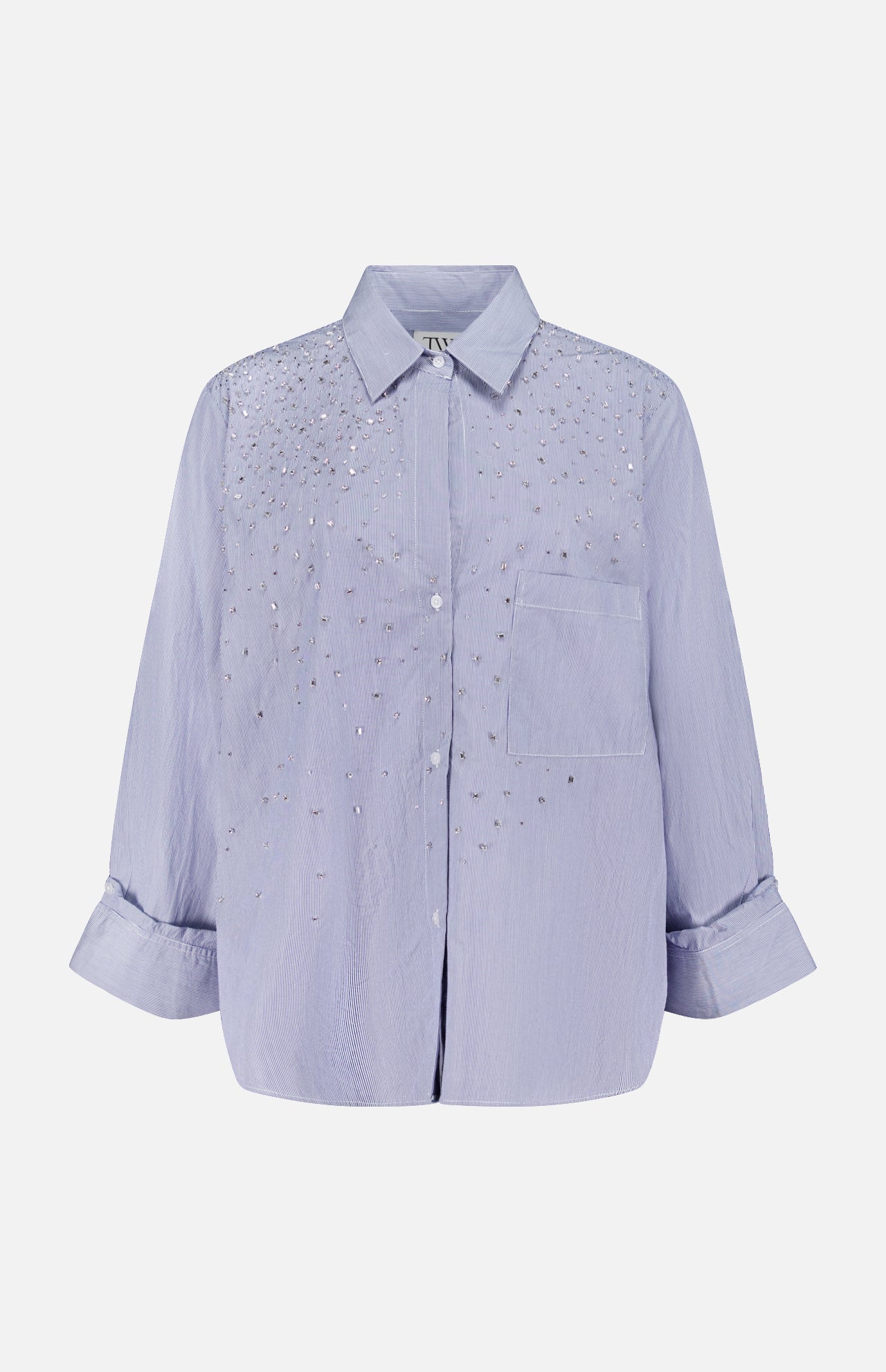 The TWP Next Morning Shirt with Crystals is a light purple, oversized Italian cotton button-down featuring a collar, front pocket, and sparkling crystal embellishments on the chest and shoulders.