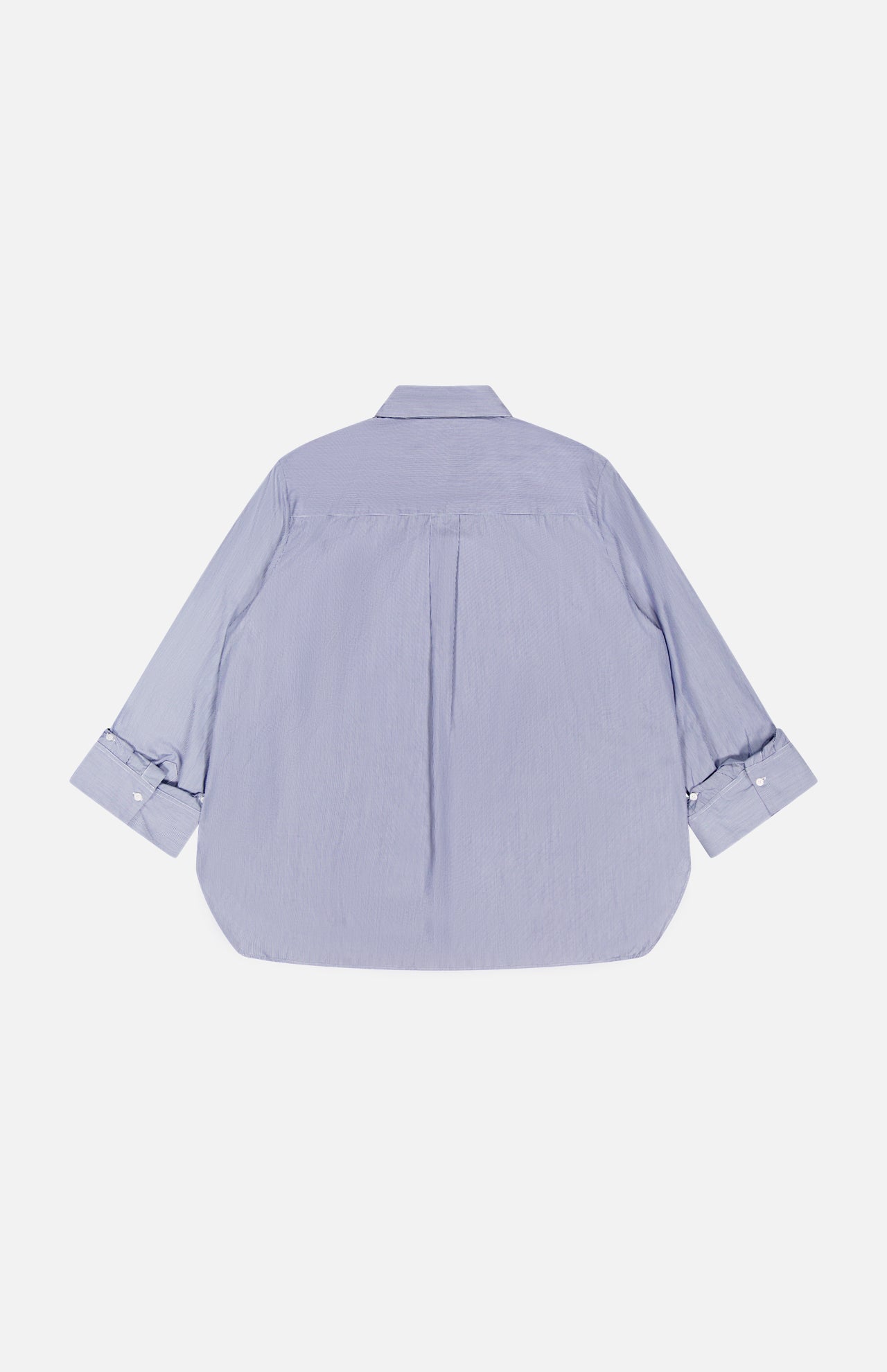 The TWP Next Morning Shirt with Crystals is shown flat in light blue, featuring long sleeves, a relaxed fit, classic collar, center back pleat, and unbuttoned cuffs. Crafted from Italian cotton with an oversized silhouette.