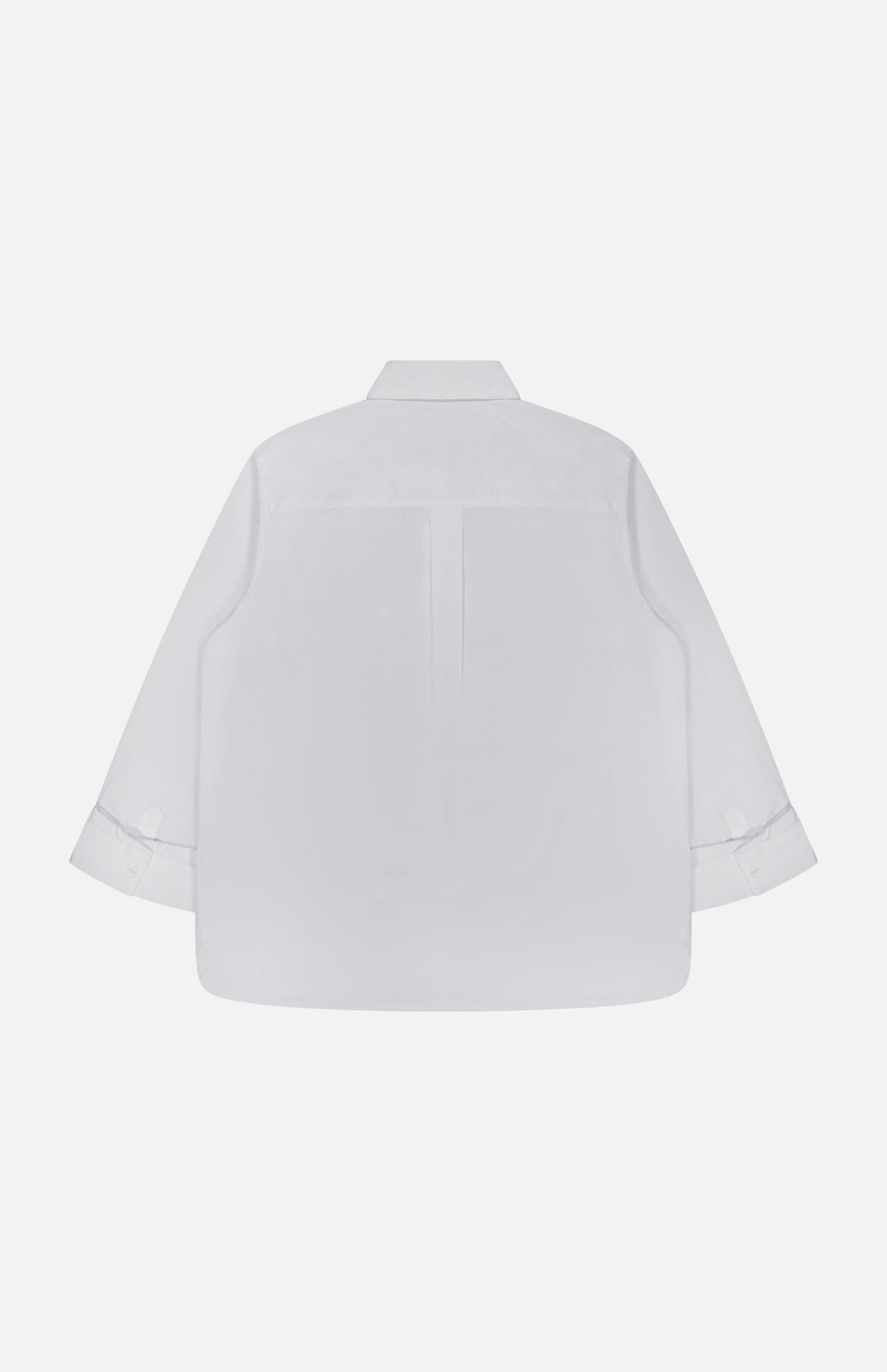 Back view of the TWP Next Morning Crystal Shirt, an oversized shirt crafted from premium Italian cotton in plain white, featuring long sleeves with buttoned cuffs and a classic collar, free from visible patterns or logos, laid flat against a white background.