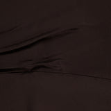 Close-up of the TWP On the Side Stretch Silk Dress in dark brown, highlighting its soft folds, subtle texture, and gentle diagonal creases for a look reminiscent of a ruched maxi dress with a smooth finish.