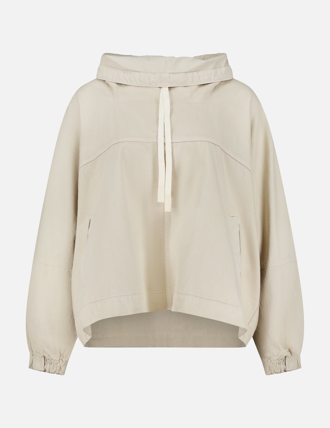 The Pull Me Over Jacket by TWP is a beige, long-sleeve hooded jacket featuring a front tie, two side pockets, and elastic cuffs—perfect as a versatile layering piece for women’s workwear—shown against a plain white background.