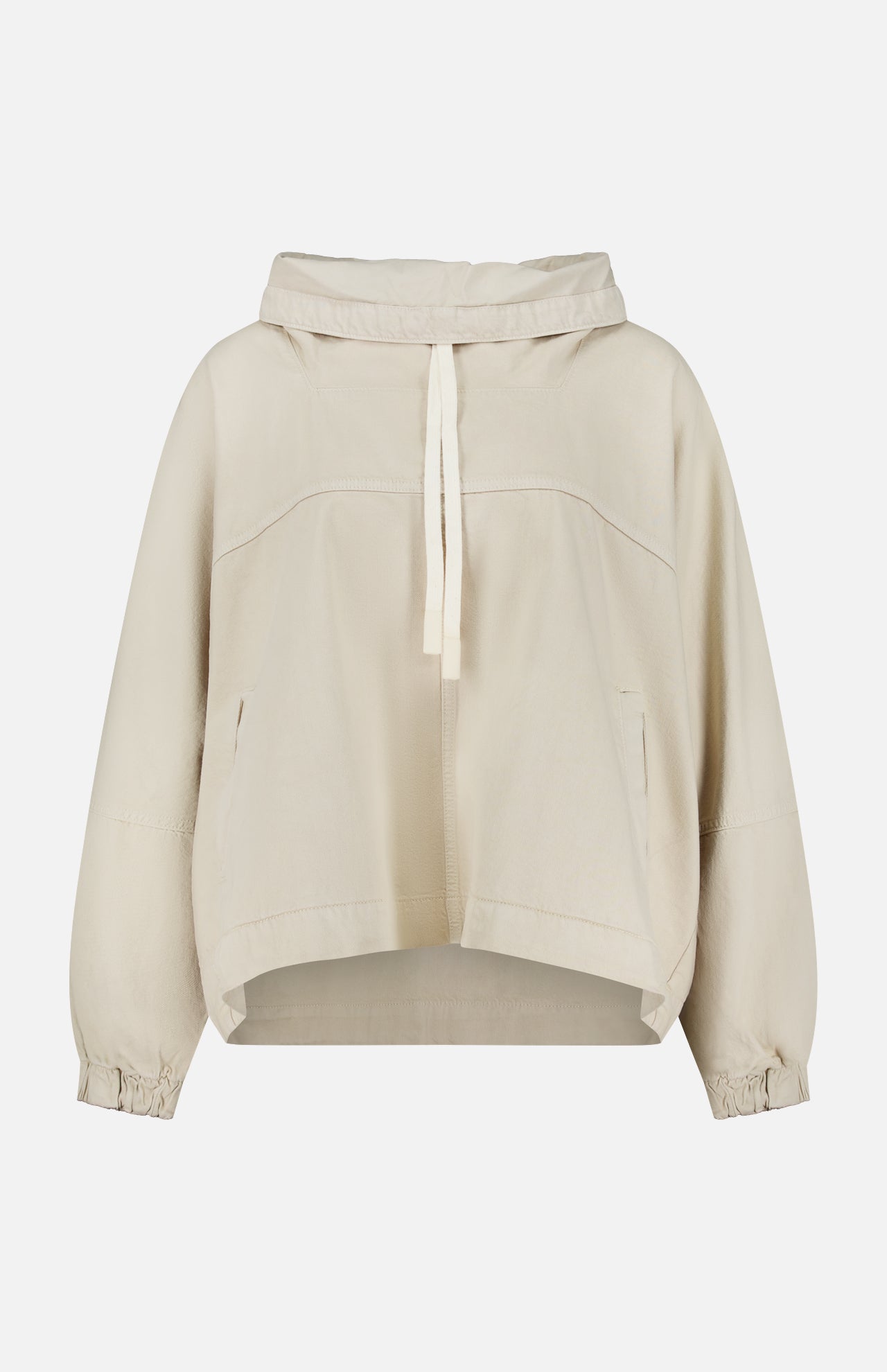 The Pull Me Over Jacket by TWP is a beige, long-sleeve hooded jacket featuring a front tie, two side pockets, and elastic cuffs—perfect as a versatile layering piece for women’s workwear—shown against a plain white background.