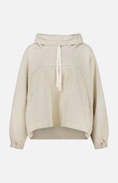 The Pull Me Over Jacket by TWP is a beige, long-sleeve hooded jacket featuring a front tie, two side pockets, and elastic cuffs—perfect as a versatile layering piece for women’s workwear—shown against a plain white background.