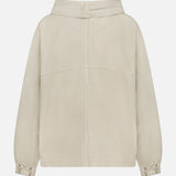 The Pull Me Over Jacket by TWP is a beige, long-sleeved layering piece for women, featuring a collar, elasticated cuffs, and a back seam. Shown from the back against a white background, this versatile jacket combines style and practicality—perfect for workwear.