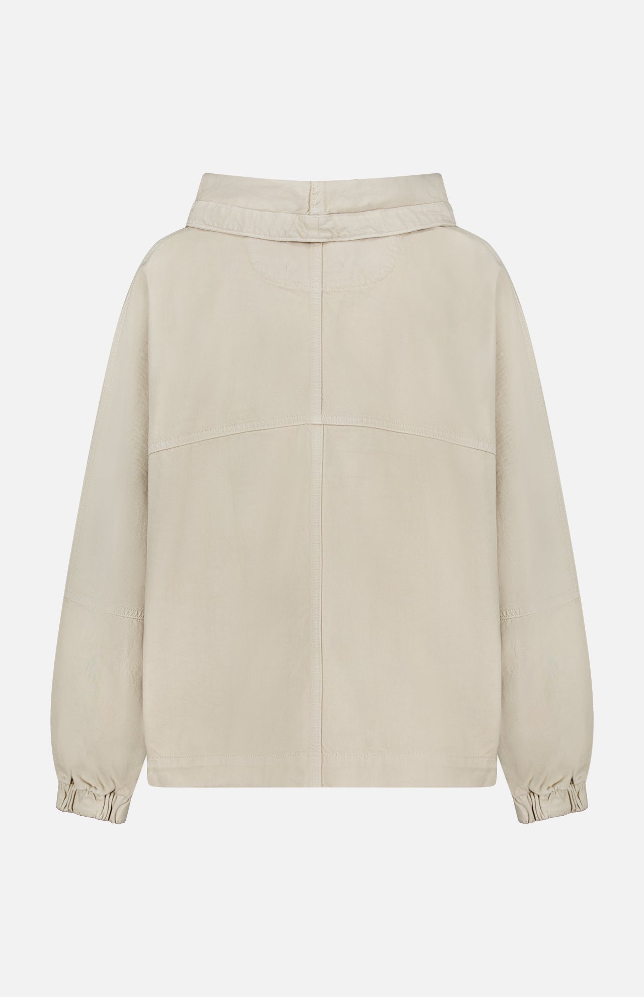 The Pull Me Over Jacket by TWP is a beige, long-sleeved layering piece for women, featuring a collar, elasticated cuffs, and a back seam. Shown from the back against a white background, this versatile jacket combines style and practicality—perfect for workwear.