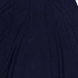 Close-up of the TWP Seamed Maxi Skirt in navy, featuring vertical seam lines and an elastic waistband. This skirt is ideal for women’s workwear, with soft fabric that gently gathers below the waist.