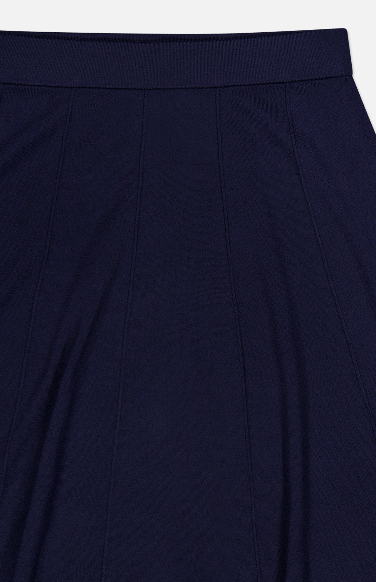 Close-up of the TWP Seamed Maxi Skirt in navy, featuring vertical seam lines and an elastic waistband. This skirt is ideal for women’s workwear, with soft fabric that gently gathers below the waist.