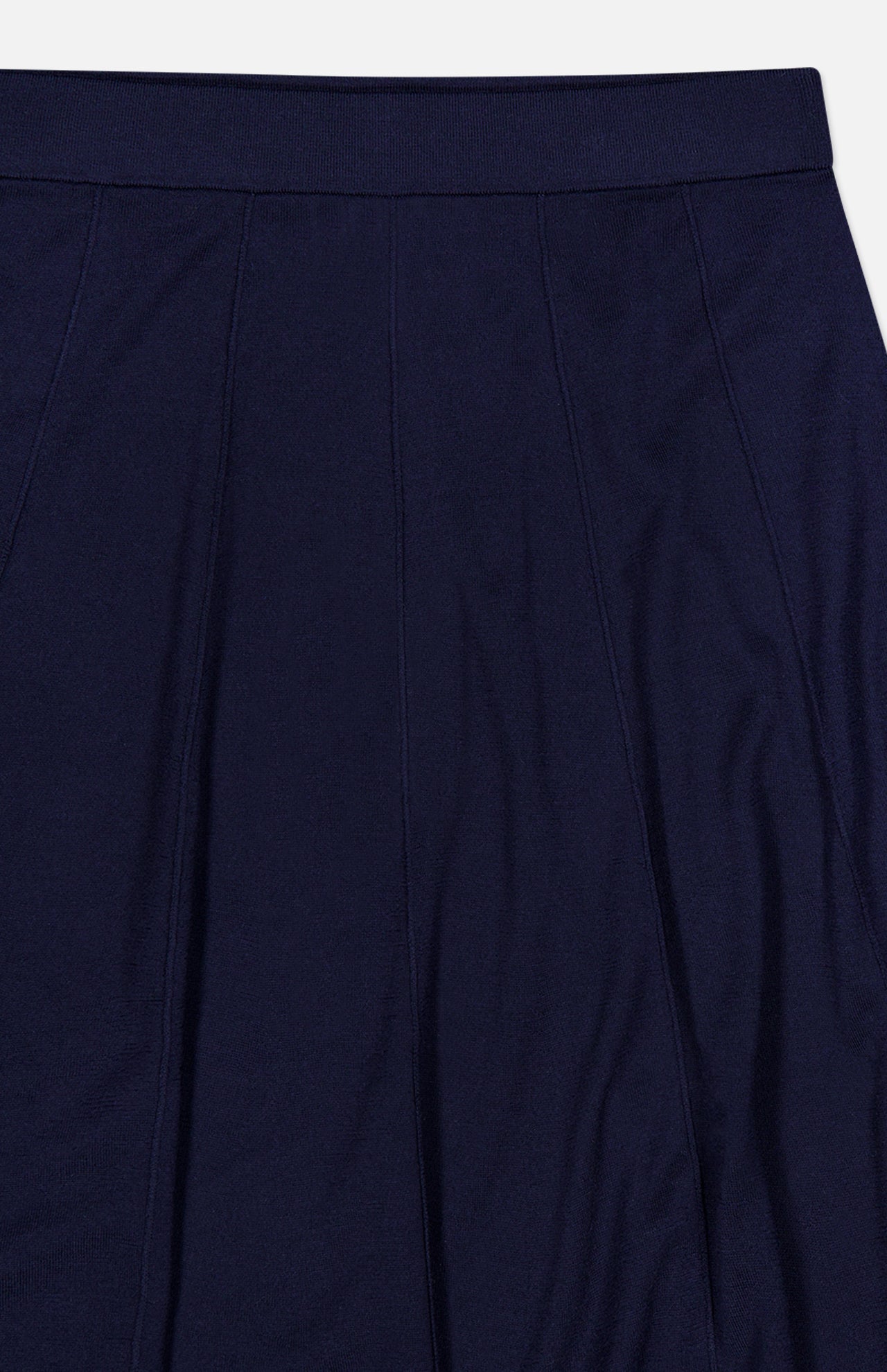 A close-up of the TWP Seamed Maxi Skirt in dark navy, highlighting its vertical seam detailing and tailored waistband against a plain background—an elegant and sophisticated workwear piece for women.