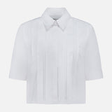 The TWP Short Lived Placket with Cherry Pleats Shirt features crisp white poplin fabric, a pointed collar, and vertical pleated detailing on the front. Displayed against a plain white background, this short-sleeve shirt is a versatile addition to any women's workwear wardrobe.